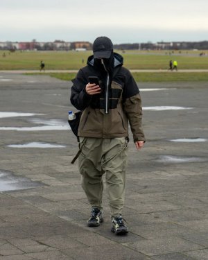 Techwear.Germany aka Janek in einer Ubahn in einem Techwear Outfit mit North Face Cap, Maske, ACRONYM J1WTS-GT Techwear Jacke und Equip Techwear Messenger Bag